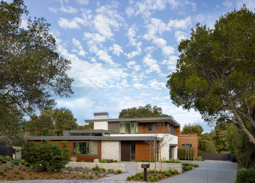 Large trendy two-story mixed siding exterior home photo in San Francisco with a mixed material roof and a gray roof