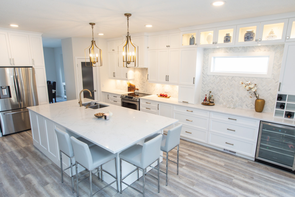 Large transitional l-shaped vinyl floor and gray floor open concept kitchen photo with an undermount sink, shaker cabinets, white cabinets, quartz countertops, white backsplash, marble backsplash, stainless steel appliances, an island and white countertops