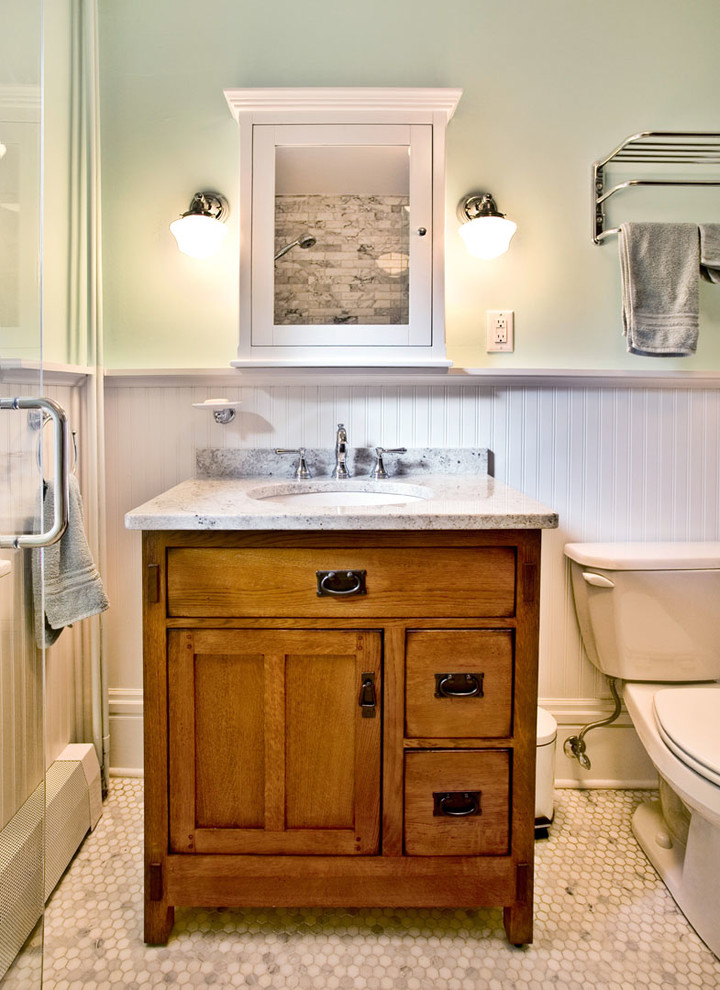 Alcove shower - small transitional 3/4 multicolored tile and mosaic tile ceramic tile and multicolored floor alcove shower idea in Minneapolis with medium tone wood cabinets, green walls, a hinged shower door, flat-panel cabinets, a one-piece toilet, an undermount sink and granite countertops