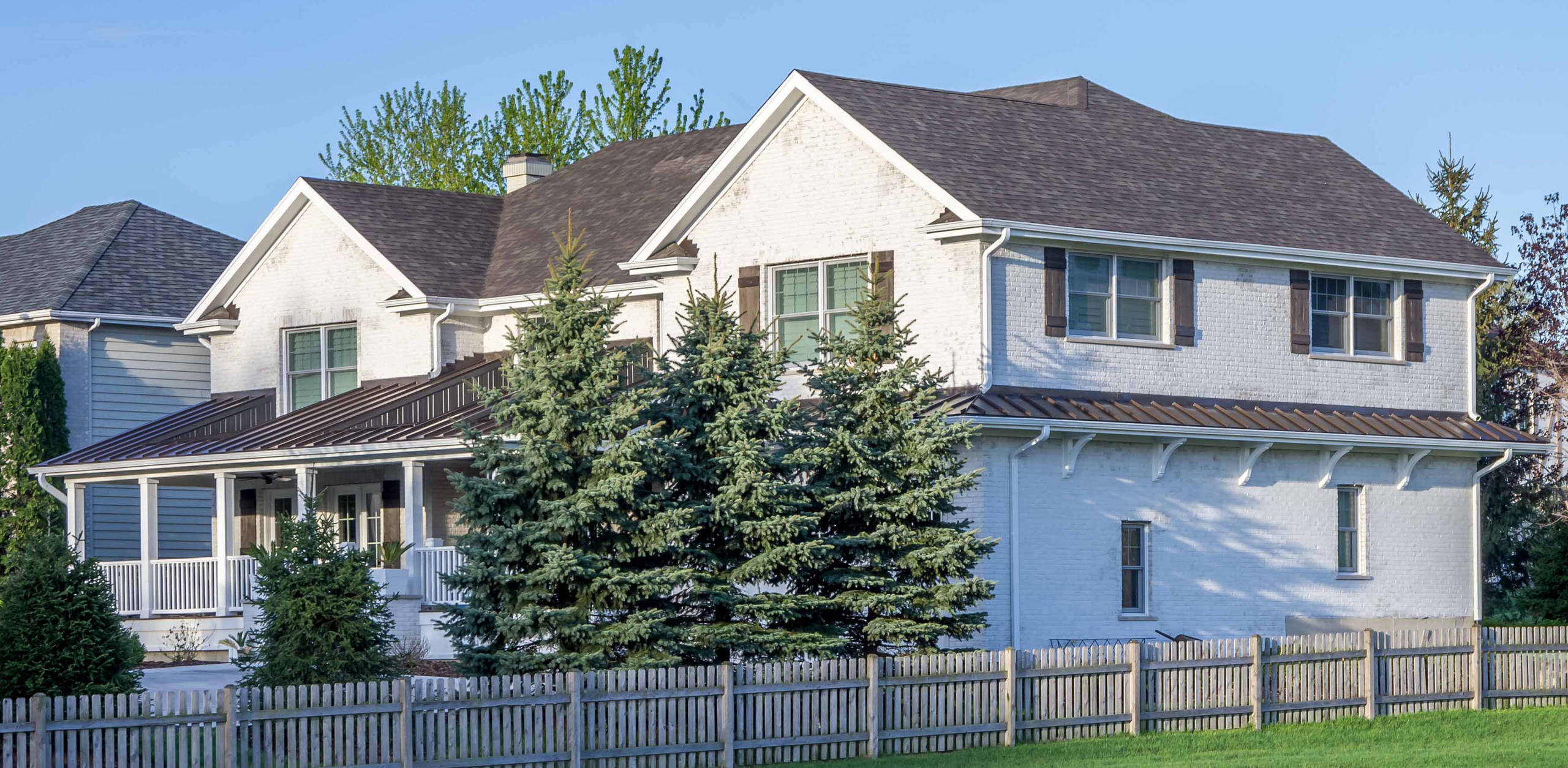 Island Inspriation - exterior lanai and side view with stained white brick detail, standing seam metal roof and architectural corbels