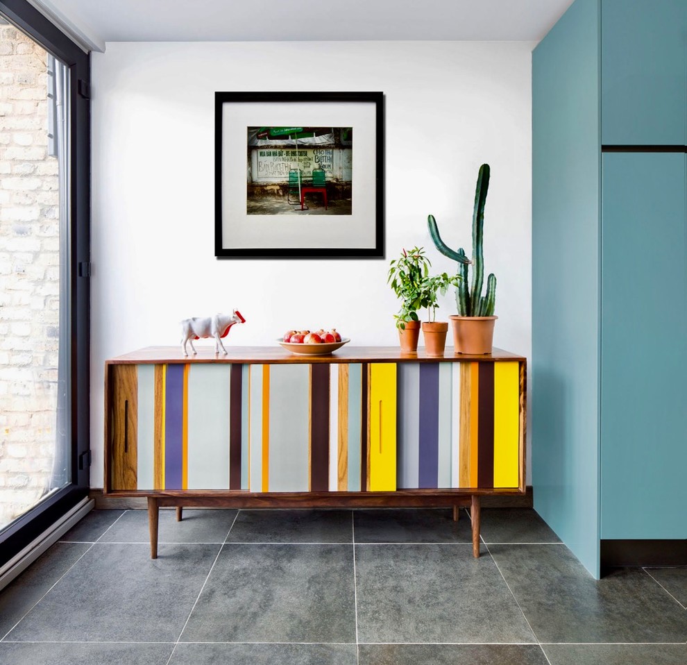 This is an example of a medium sized contemporary kitchen in London with flat-panel cabinets, turquoise cabinets, ceramic flooring, an island and grey floors.