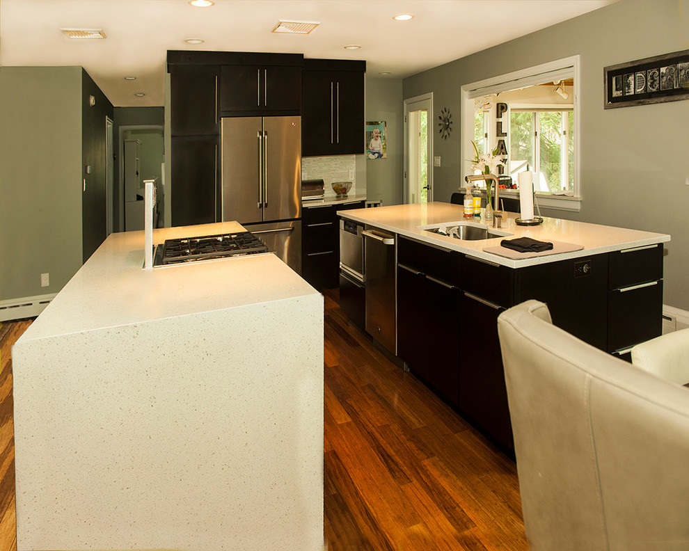 Example of a kitchen design in Chicago with flat-panel cabinets, dark wood cabinets and two islands