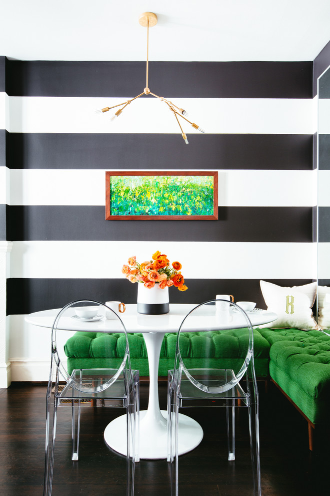 This is an example of a contemporary dining room in San Francisco with dark hardwood floors and multi-coloured walls.