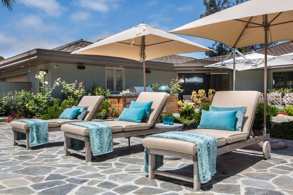 Inspiration for a large transitional backyard patio in San Diego with natural stone pavers.