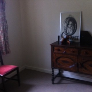 Decluttered reception room used as a storage room