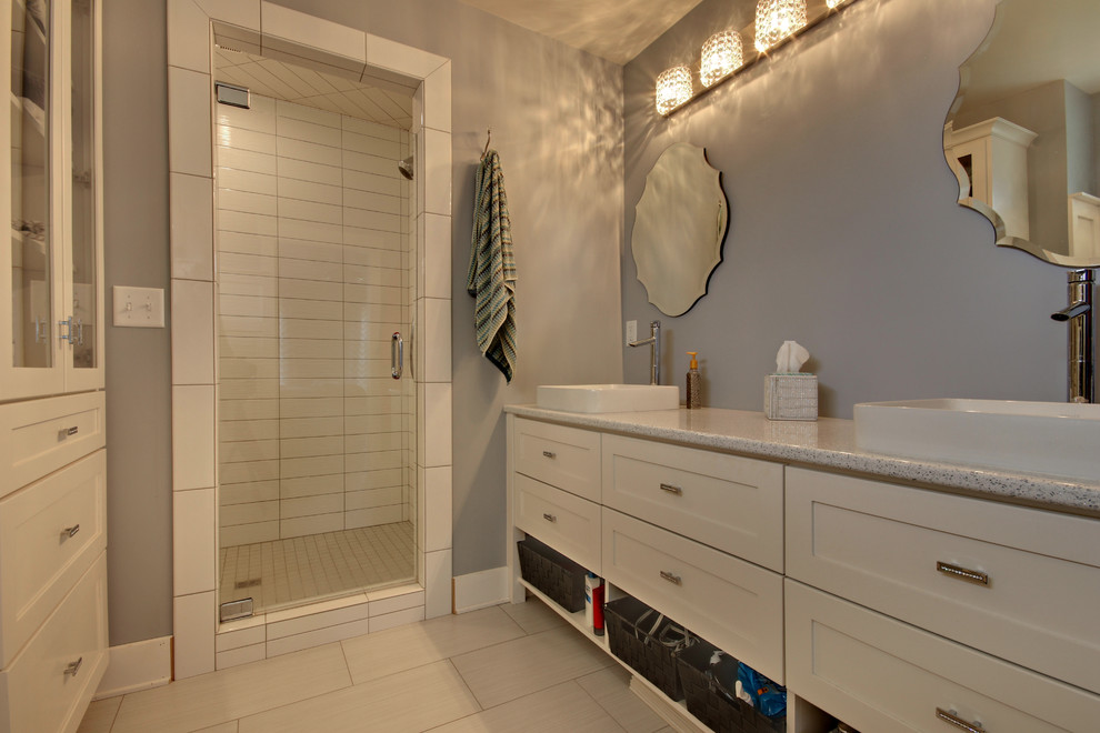 Inspiration for a mid-sized contemporary master bathroom in Grand Rapids with recessed-panel cabinets, white cabinets, a claw-foot tub, a double shower, white walls, porcelain floors, a vessel sink, engineered quartz benchtops, white floor and a hinged shower door.