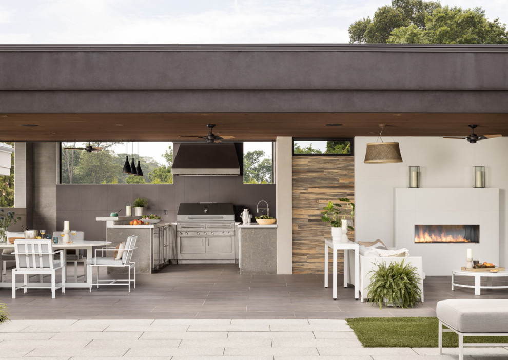 Inspiration for a contemporary patio in Newark with an outdoor kitchen, tile and a roof extension.