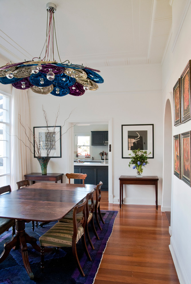Inspiration for a dining room in Perth with white walls and medium hardwood floors.