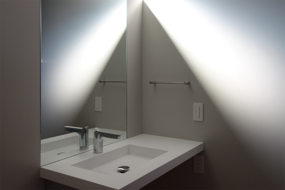 Design ideas for a small modern powder room in Tokyo with open cabinets, light wood cabinets, grey walls, light hardwood floors and a wall-mount sink.
