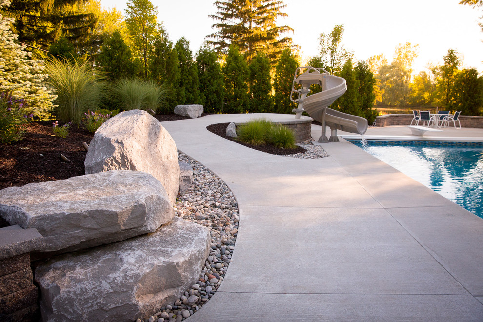 Example of a minimalist backyard concrete and rectangular water slide design in Grand Rapids