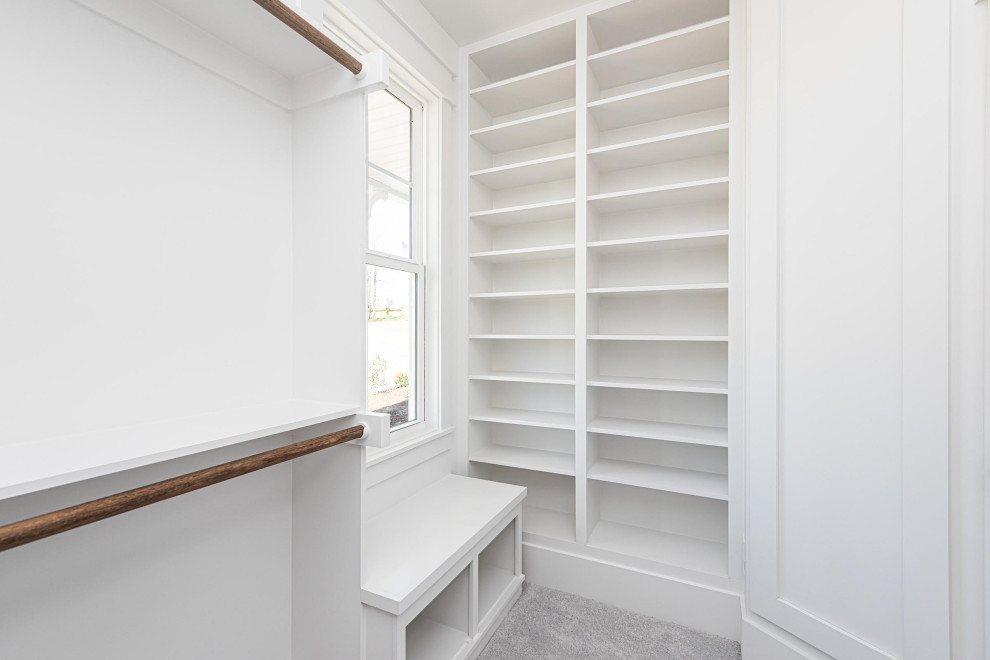 Design ideas for a medium sized traditional walk-in wardrobe in Raleigh with open cabinets, white cabinets, carpet and grey floors.
