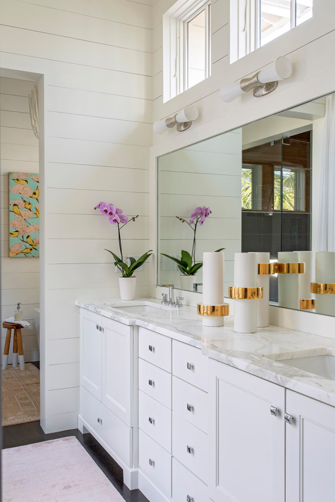 Beach style bathroom in Charleston with recessed-panel cabinets, white cabinets, white tile, white walls, dark hardwood floors, an undermount sink, brown floor, white benchtops, a double vanity, a built-in vanity and planked wall panelling.