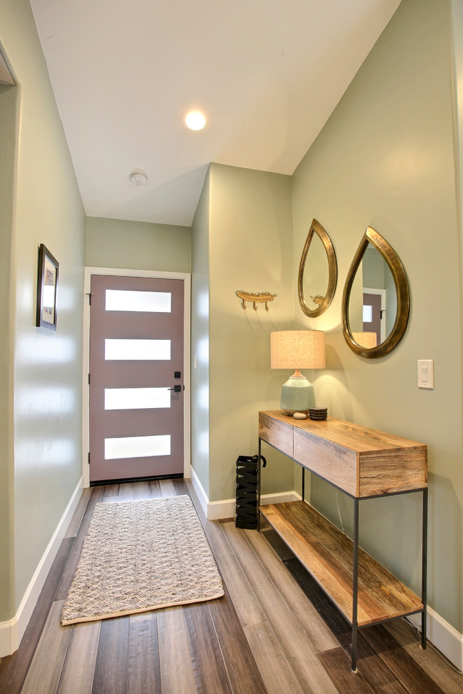 Design ideas for a mid-sized modern front door in Other with green walls, bamboo floors, a single front door, a purple front door and grey floor.