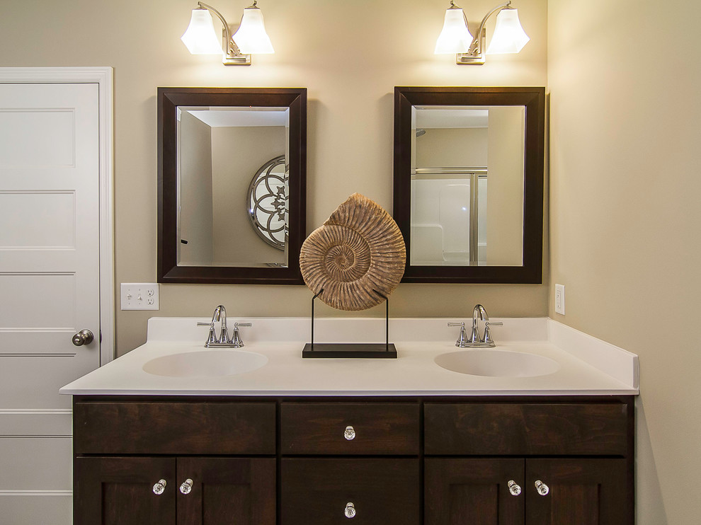 Photo of a mid-sized contemporary master bathroom in Minneapolis with shaker cabinets, dark wood cabinets, beige walls and an integrated sink.