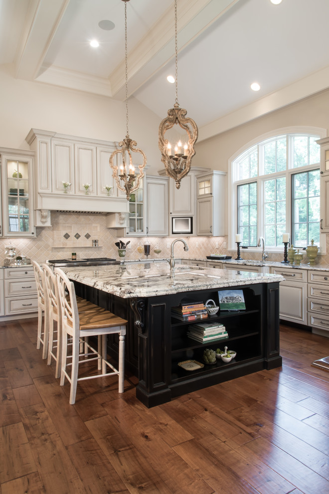 Design ideas for an expansive traditional open plan kitchen in Other with raised-panel cabinets, white cabinets, beige splashback, dark hardwood floors, with island, brown floor, an undermount sink, granite benchtops and stainless steel appliances.