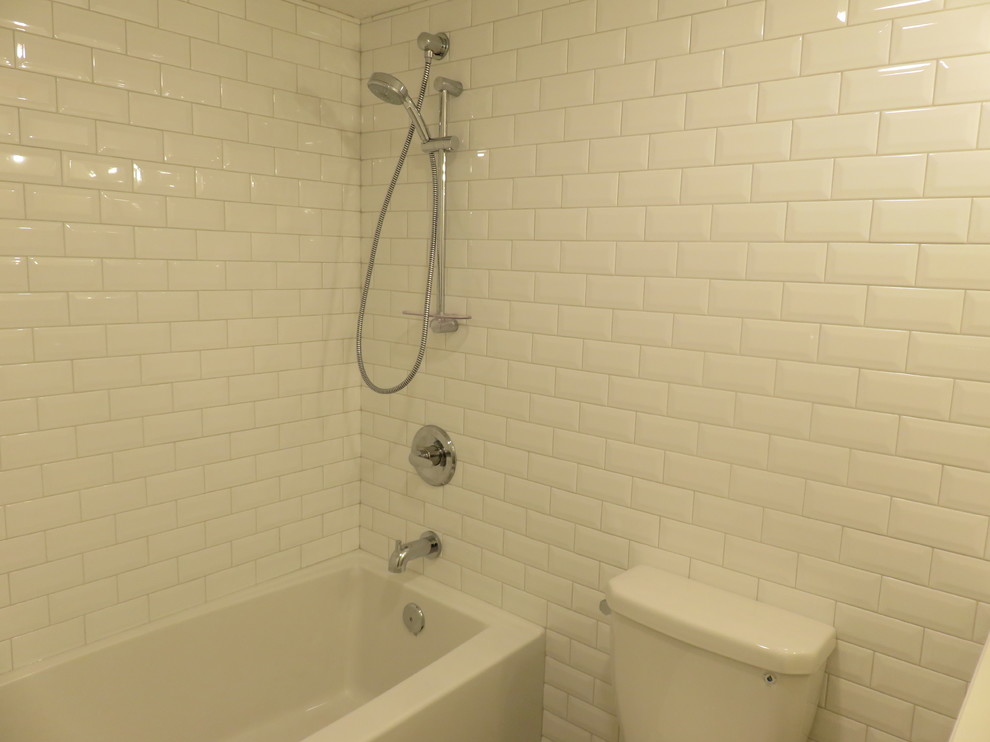Example of a small transitional kids' white tile and subway tile ceramic tile and gray floor alcove bathtub design in Calgary with louvered cabinets, white cabinets, a two-piece toilet, white walls, an undermount sink and quartzite countertops