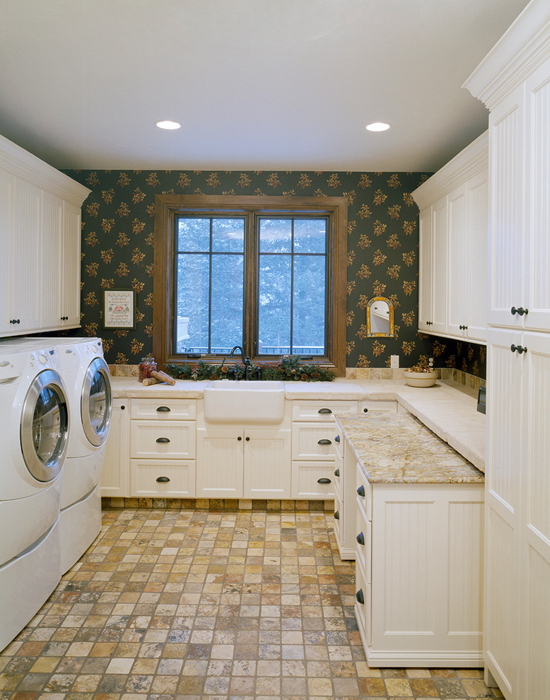 This is an example of a large traditional u-shaped dedicated laundry room in Denver with a farmhouse sink, recessed-panel cabinets, white cabinets, granite benchtops, multi-coloured walls and a side-by-side washer and dryer.