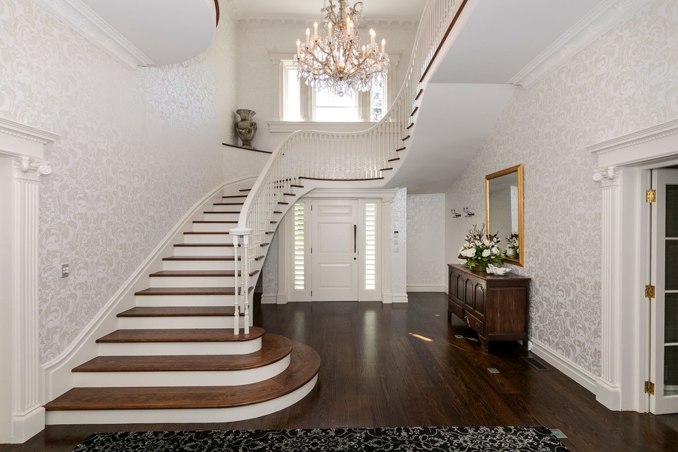 Traditional wood u-shaped staircase in Auckland with wood railing.
