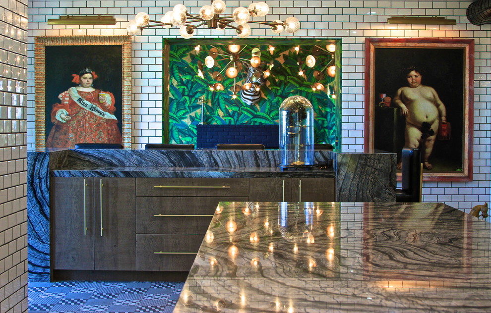 Huge eclectic l-shaped ceramic tile enclosed kitchen photo in Orange County with an undermount sink, flat-panel cabinets, gray cabinets, marble countertops, white backsplash, subway tile backsplash, black appliances and an island