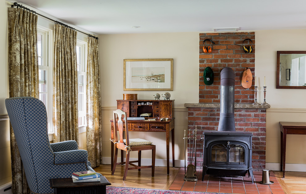 Inspiration for a small traditional family room in Boston with a brick fireplace surround.