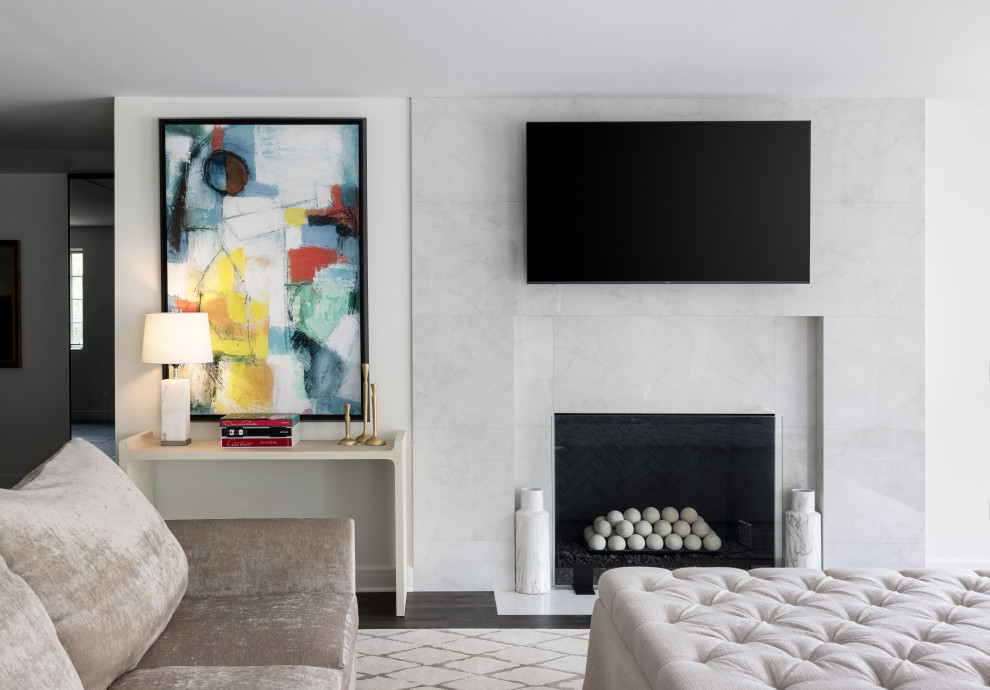 Источник вдохновения для домашнего уюта: большая открытая гостиная комната в стиле неоклассика (современная классика) с белыми стенами, полом из винила, стандартным камином, фасадом камина из камня, телевизором на стене и коричневым полом