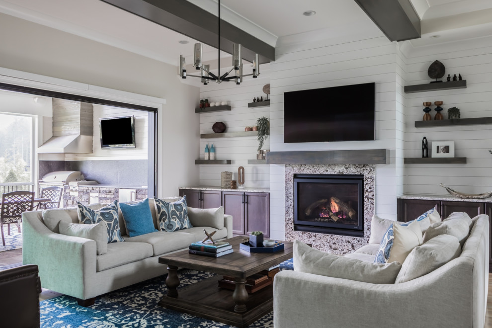 Photo of a mid-sized transitional open concept living room in Raleigh with light hardwood floors, a standard fireplace, a stone fireplace surround, a wall-mounted tv, exposed beam, white walls and planked wall panelling.
