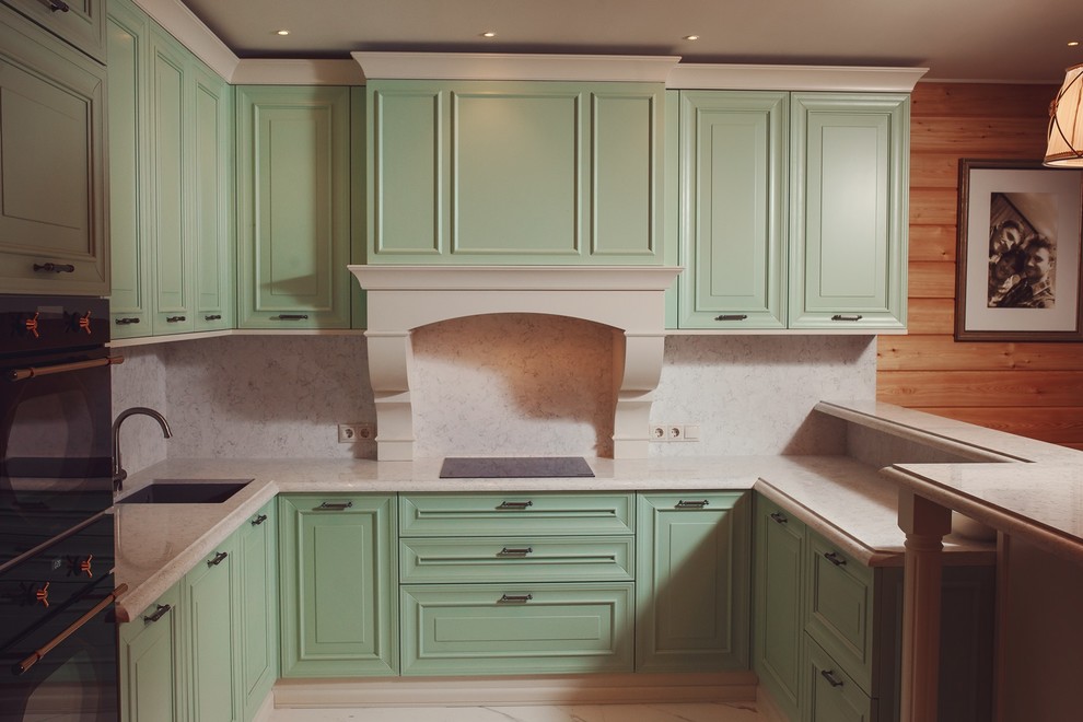 This is an example of a large traditional kitchen in Moscow with quartz benchtops.