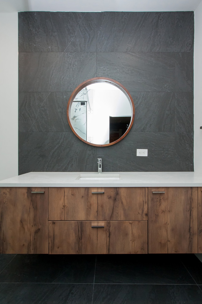 This is an example of a contemporary bathroom in Dallas with flat-panel cabinets, dark wood cabinets, a corner shower, a one-piece toilet, black tile, porcelain tile, white walls, porcelain floors, an undermount sink, engineered quartz benchtops, black floor, a hinged shower door, white benchtops, a single vanity and a floating vanity.