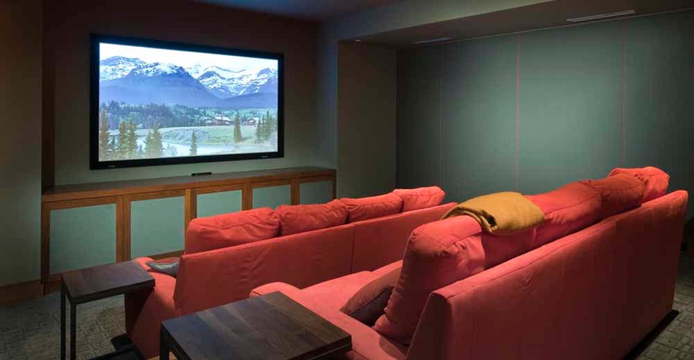 Photo of a large modern enclosed home theatre in Denver with green walls, carpet and a built-in media wall.