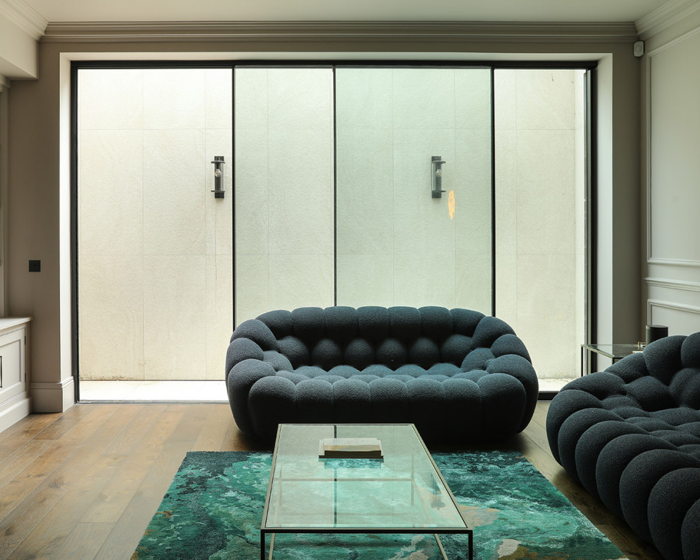 Photo of a transitional family room in London.