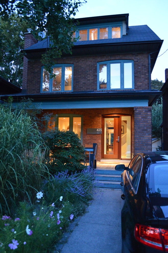 Traditional two-storey brick red exterior in Toronto.