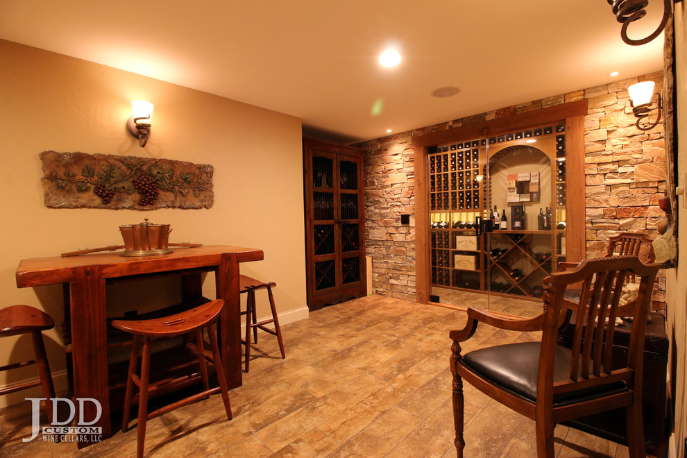 Large traditional wine cellar in Cincinnati with ceramic floors and storage racks.