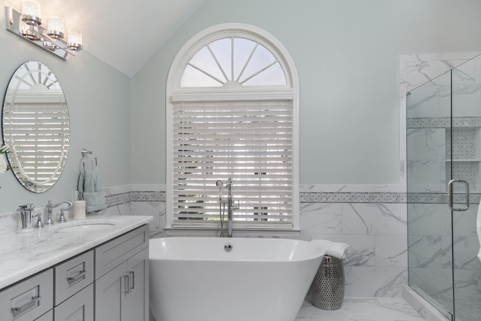 This is an example of a large transitional master bathroom in Atlanta with shaker cabinets, grey cabinets, a freestanding tub, white tile, gray tile, green walls, porcelain floors, an undermount sink, quartzite benchtops, white floor, a hinged shower door, white benchtops, an alcove shower and porcelain tile.