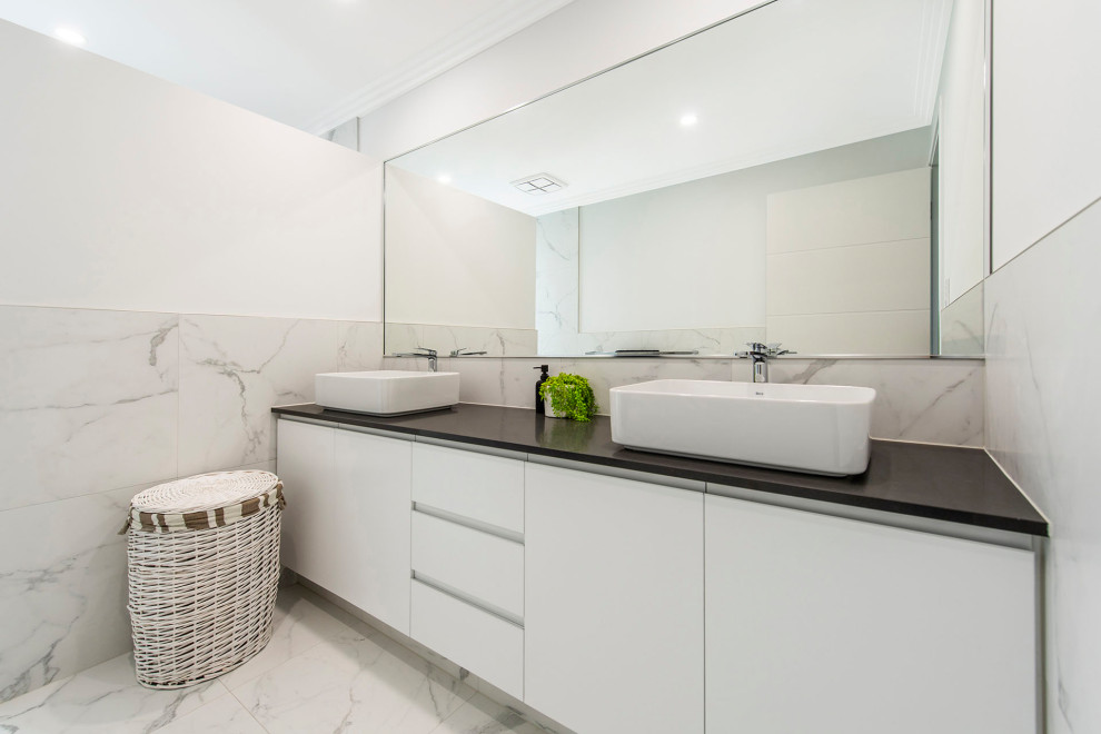 Photo of a mid-sized contemporary 3/4 bathroom in Perth with white cabinets, a vessel sink and engineered quartz benchtops.