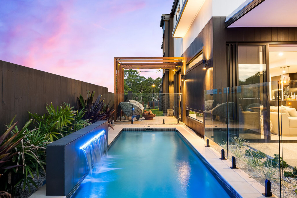 Contemporary rectangular pool in Brisbane with a water feature.