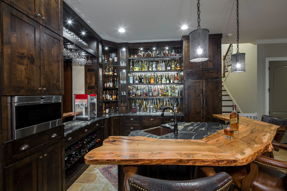 Country l-shaped wet bar in Charlotte with an undermount sink, shaker cabinets, dark wood cabinets, wood benchtops, beige floor and brown benchtop.