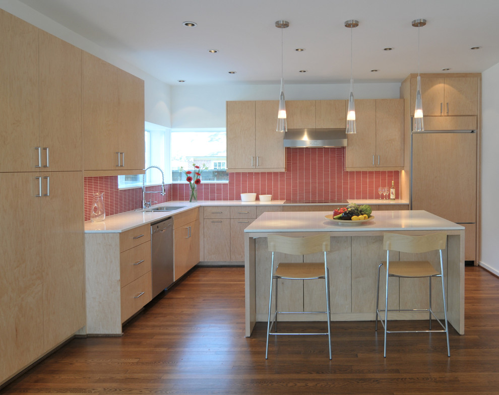 This is an example of a modern l-shaped kitchen in Houston with panelled appliances, red splashback, light wood cabinets, flat-panel cabinets and a double-bowl sink.