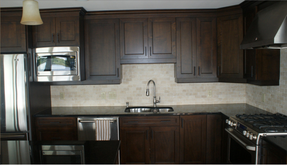 Inspiration for a transitional u-shaped enclosed kitchen remodel in Ottawa with a double-bowl sink, raised-panel cabinets, dark wood cabinets, granite countertops, beige backsplash, cement tile backsplash, stainless steel appliances and an island