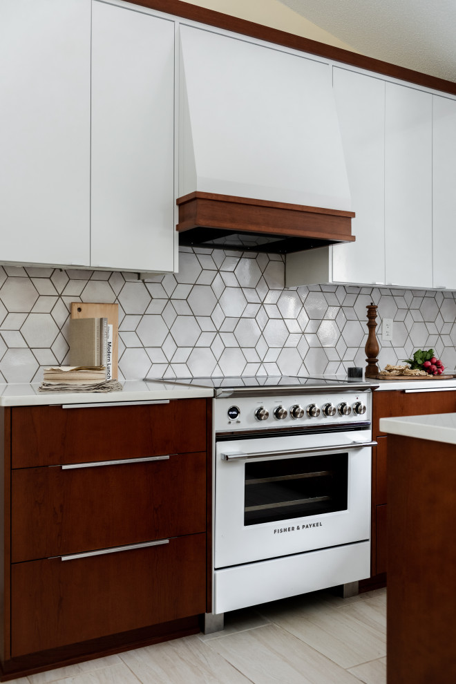 Inspiration for a midcentury l-shaped eat-in kitchen in Minneapolis with white cabinets, quartz benchtops, grey splashback, mosaic tile splashback, white appliances and white benchtop.
