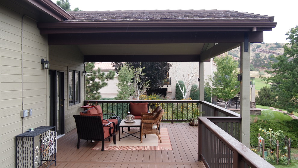 Design ideas for a large transitional backyard deck in Denver with a roof extension.