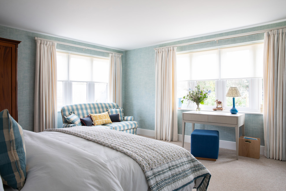 Photo of a mid-sized contemporary guest bedroom in Sussex with green walls, carpet and beige floor.