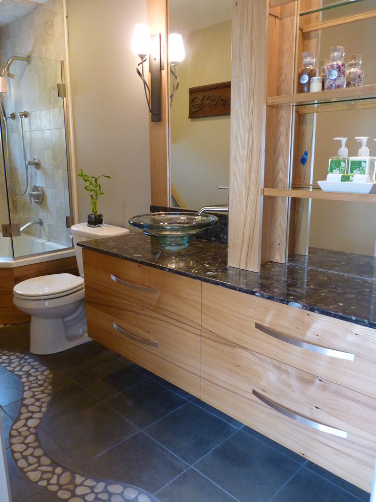 Large eclectic master bathroom in Burlington with flat-panel cabinets, light wood cabinets, a two-piece toilet, grey walls, ceramic floors, a vessel sink, marble benchtops and grey floor.