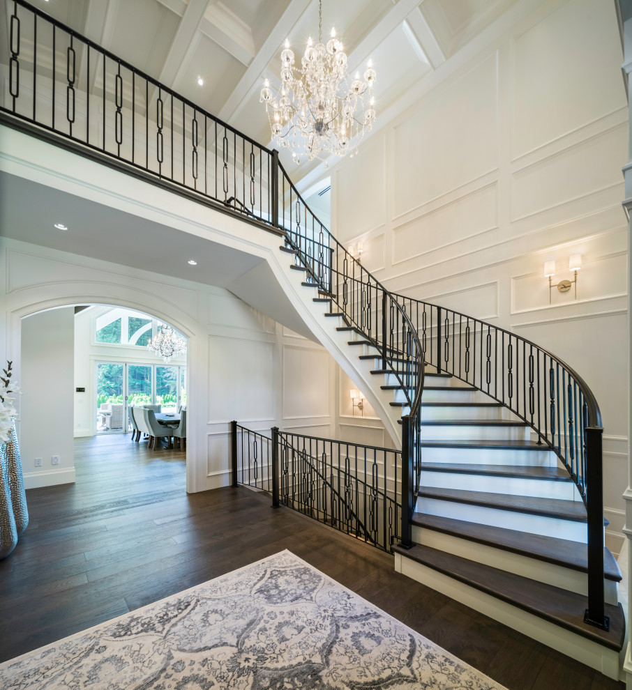Inspiration for an expansive classic wood spiral wood railing staircase in Vancouver with open risers.