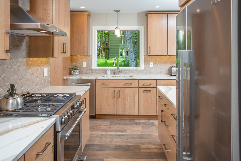 Example of a mid-sized transitional galley eat-in kitchen design with flat-panel cabinets, medium tone wood cabinets, quartz countertops and stainless steel appliances