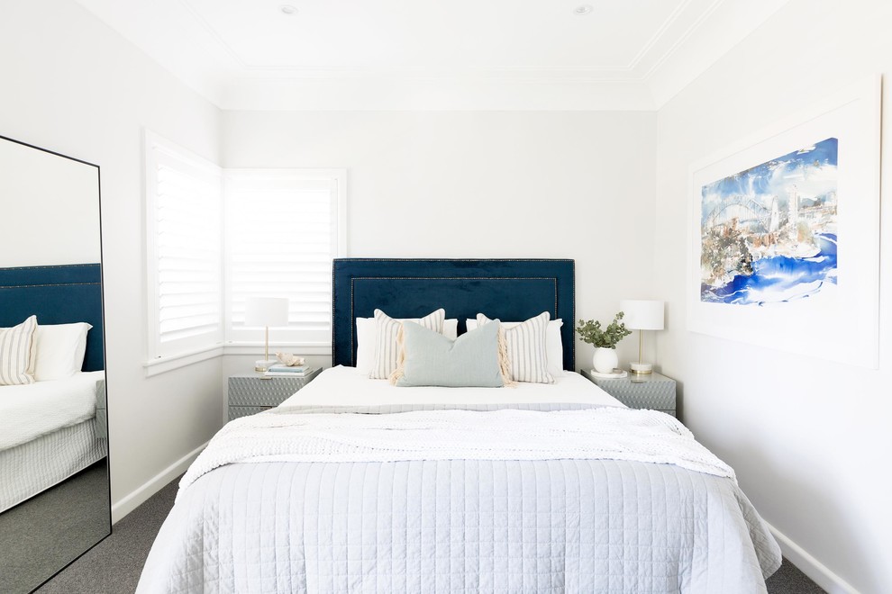 Inspiration for a beach style guest bedroom in Sydney with white walls, carpet and grey floor.
