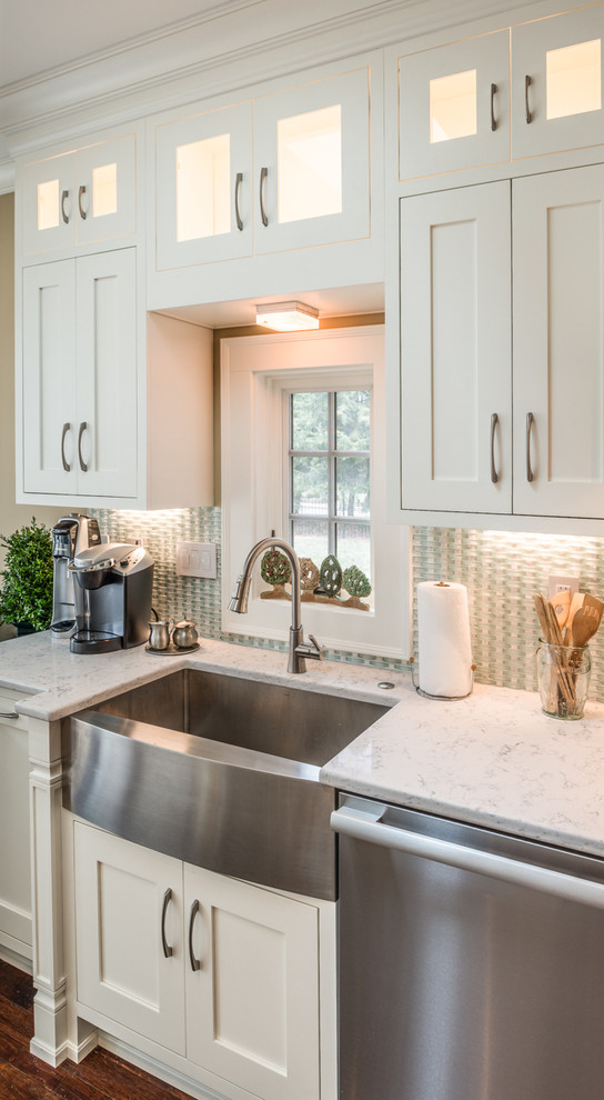 Large transitional l-shaped eat-in kitchen in Indianapolis with a farmhouse sink, shaker cabinets, white cabinets, quartz benchtops, blue splashback, mosaic tile splashback, stainless steel appliances, medium hardwood floors and a peninsula.
