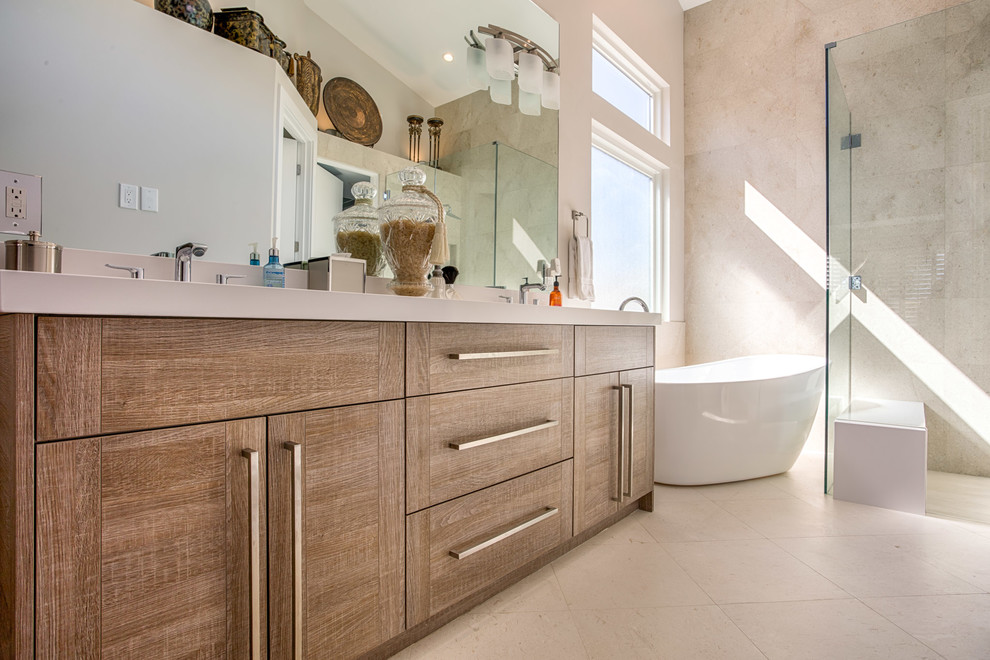 This is an example of a large contemporary master bathroom in Phoenix with flat-panel cabinets, medium wood cabinets, a freestanding tub, a curbless shower, beige walls, linoleum floors, beige floor and a hinged shower door.