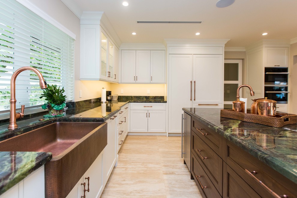 Example of a large transitional u-shaped light wood floor open concept kitchen design in Miami with a farmhouse sink, shaker cabinets, stainless steel appliances, an island, white cabinets, granite countertops, metallic backsplash and mosaic tile backsplash
