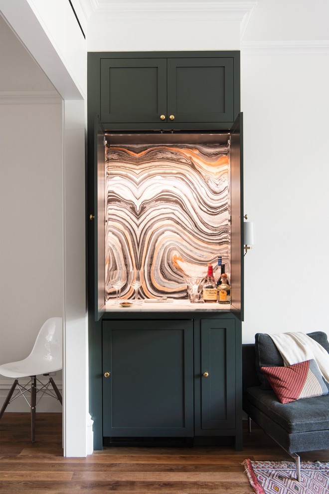 Small transitional single-wall home bar in Raleigh with shaker cabinets, multi-coloured splashback, medium hardwood floors, grey cabinets, no sink, marble benchtops, stone slab splashback and brown floor.