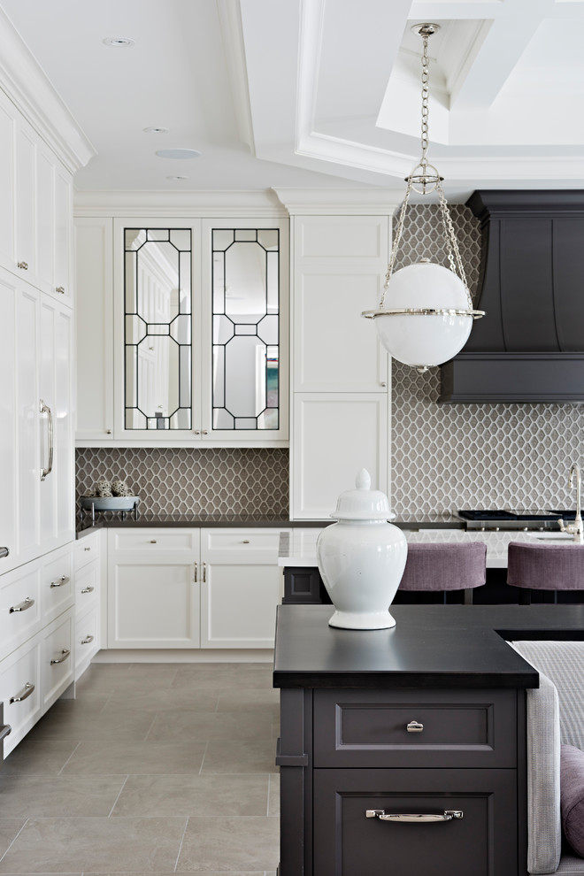 Inspiration for a large traditional u-shaped separate kitchen in Toronto with an undermount sink, shaker cabinets, white cabinets, quartz benchtops, brown splashback, mosaic tile splashback, stainless steel appliances, ceramic floors, multiple islands, grey floor and grey benchtop.